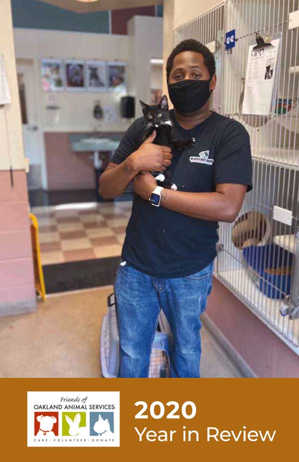 An image of the cover of the Year in Review features Donnell, shelter staff, holding a kitten at the shelter.